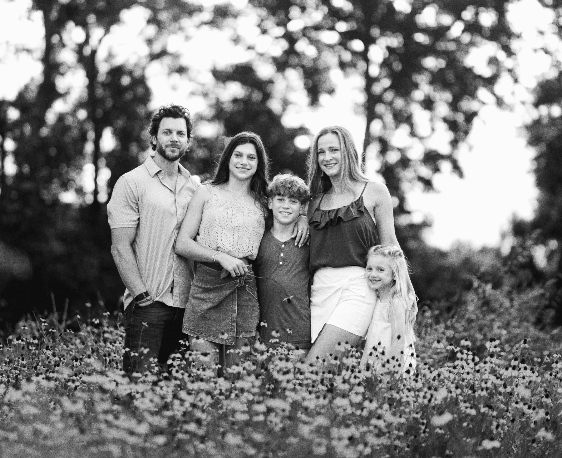 The Lipari family standing in a field of wildflowers