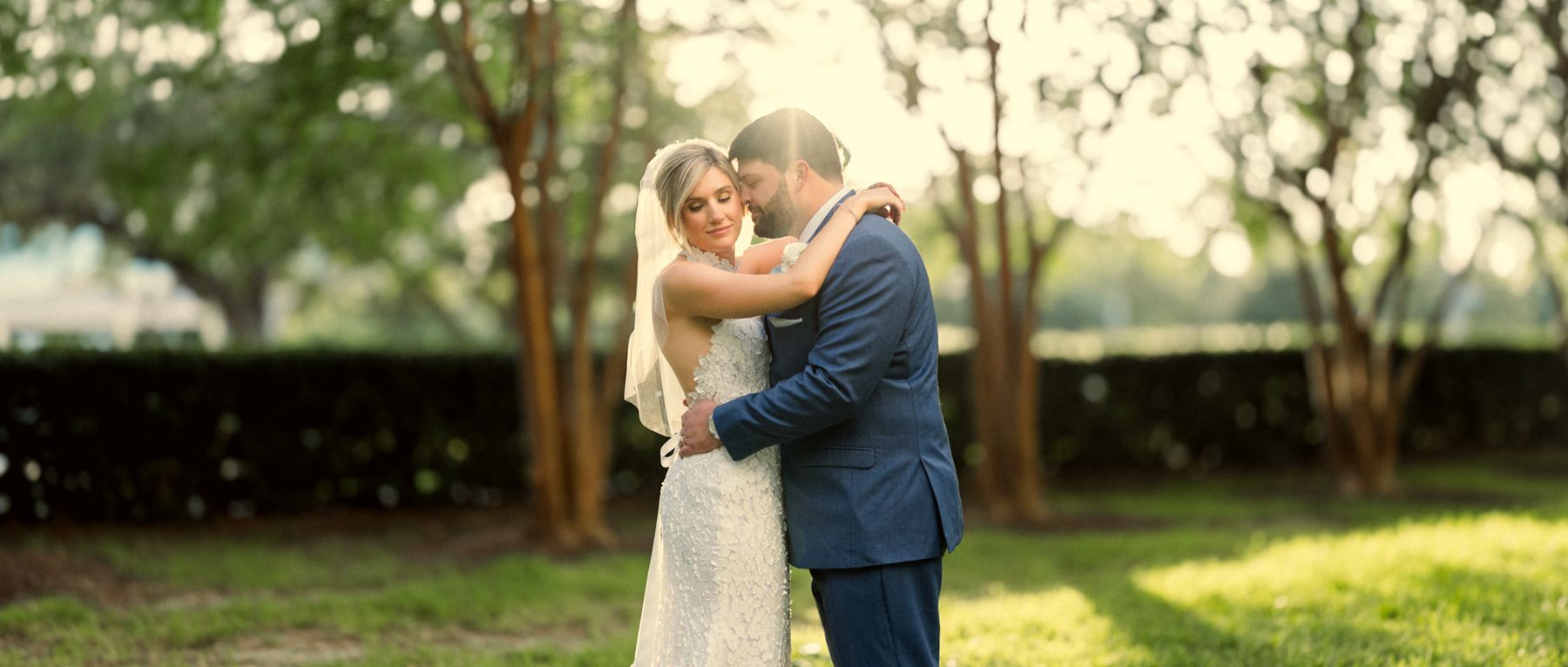 Newlyweds embracing under the oaks