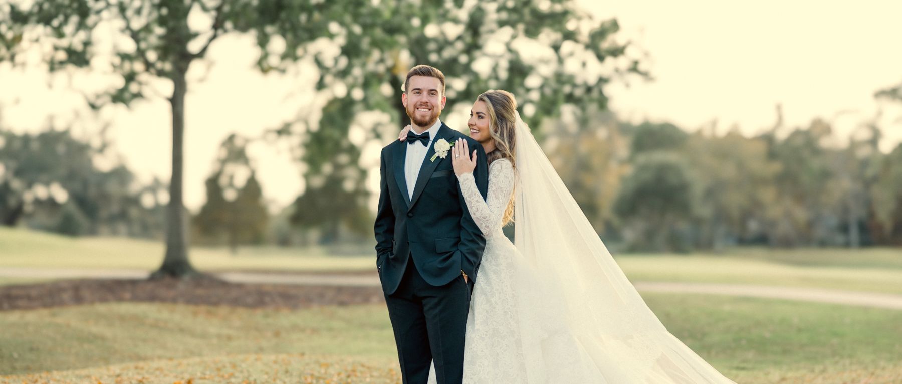Couple touching foreheads under live oaks